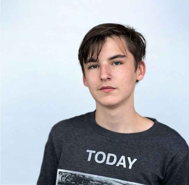 student wearing t-shirt looking at camera