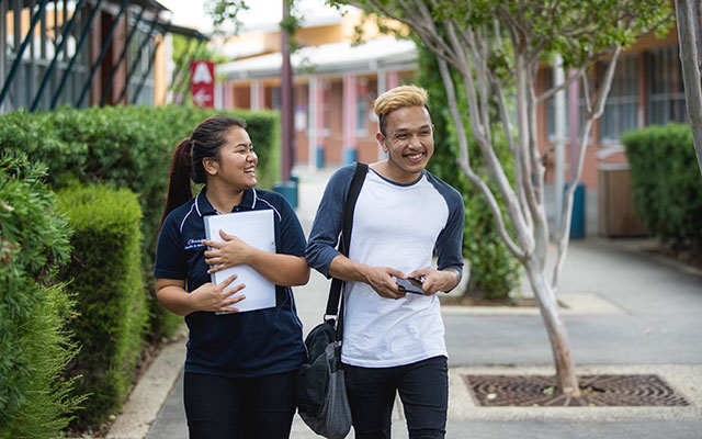 two Chisholm students walking through campus
