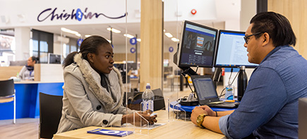 Two staff members waiting to assist a customer